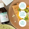 A bottle of Norsan Omega-3 Fisk liquid next to a crepe with filling, with marketing text overlays. Produktbild-Vorschau