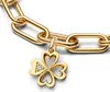 A close-up shot of a gold bracelet chain with a four-leaf clover charm. Produktbild-Vorschau