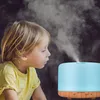 A young child is looking at a humidifier emitting mist. Anteprima dell’immagine prodotto