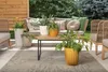 An outdoor patio setting with furniture and plants. Anteprima dell’immagine prodotto