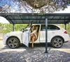 A woman is getting out of a white car parked under a carport. Voir les images du produit