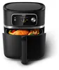 A black Philips air fryer with a chicken and vegetables inside the basket, shown with the basket pulled out. Podgląd zdjęcia produktu