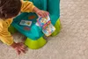 A child is playing with a colorful toy chair. Anteprima dell’immagine prodotto