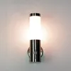 A modern stainless steel outdoor wall light with a motion sensor is mounted on a textured wall. Produktbild-Vorschau