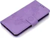 A purple flip case for a Huawei P30 Lite phone with a mandala pattern embossed on the cover. Produktbild-Vorschau