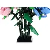 A close-up view of a Lego flower bouquet with pink and blue flowers, green leaves, and white accents, set in a black vase. Náhľad obrázku produktu