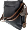 A dark blue handbag with brown straps and a plaid heart-shaped charm is shown from a side-back angle against a white background. Produktbild-Vorschau