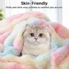A cat is nestled in a fluffy, rainbow-colored blanket. Produktbild-Vorschau