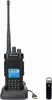 A black handheld radio and its charging dock are shown on a white background, with a small black accessory to the right. Podgląd zdjęcia produktu