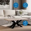A modern living room scene featuring a coffee table with a unique metal base and a light wood top, placed in front of a sofa. Náhled obrázku produktu
