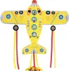 A yellow airplane-shaped kite with colorful decorations and streamers. Voir les images du produit