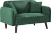 A green corduroy sofa with wooden legs and two throw pillows. Podgląd zdjęcia produktu