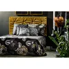 A luxurious bedroom setting with a bed dressed in a black and floral patterned duvet cover and matching pillows, against a tufted gold headboard. Produktbild-Vorschau