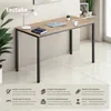 A modern desk in a home office setting, with decorative elements and product feature callouts. Produktbild-Vorschau