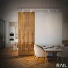 A modern dining area and kitchen separated by a wooden slat divider, with a table and chairs in the foreground. Produktbild-Vorschau