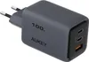 A close-up, angled view of a gray AUKEY 100W PD GaN charger with two USB-C ports and one USB-A port. Náhľad obrázku produktu