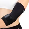 A close-up shot of a person wearing a black elbow brace. Podgląd zdjęcia produktu