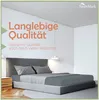 A bed with grey bedding in a minimalist room setting. Produktbild-Vorschau