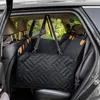 The image shows a black quilted dog seat cover installed in the back seat of a car. Produktbild-Vorschau