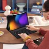 A person is using a tablet with a keyboard case on a wooden table. Produktbild-Vorschau