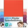 A stack of colorful fitted sheets with a child sleeping on a pillow in the foreground. Produktbild-Vorschau