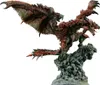 A detailed statue of a red dragon perched on a rocky outcrop. Produktbild-Vorschau