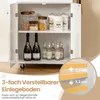 A white kitchen cart with its doors open, displaying shelves stocked with jars, bottles, and cans. A diagram illustrating adjustable shelf height is overlaid on the bottom right. Podgląd zdjęcia produktu