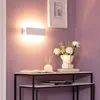 A modern hallway or entryway with a console table, a wall lamp, and decorative items. Produktbild-Vorschau