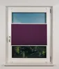 A window with purple pleated blinds partially covering it, revealing a green forest scene and blue sky. Produktbild-Vorschau