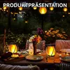 An outdoor table setting at night, illuminated by decorative lanterns and string lights. Produktbild-Vorschau