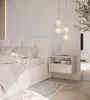A bedside table with a drawer is shown next to a bed in a bright, modern bedroom. Produktbild-Vorschau