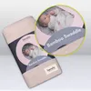 A baby swaddle product displayed in its packaging, with a close-up inset showing a baby wrapped in the swaddle. Náhľad obrázku produktu