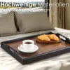A wooden tray with a cup of coffee and two croissants on a bed. Anteprima dell’immagine prodotto