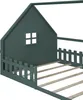 Close-up view of a green house-shaped bed frame with a picket fence detail and wooden slats. Produktbild-Vorschau