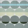 A pattern of overlapping circles in various shades of green and blue against a white background. Produktbild-Vorschau