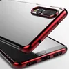 A close-up, angled view of a transparent phone case with a metallic red frame, showcasing the camera cutout and the phone's reflective surface. Anteprima dell’immagine prodotto