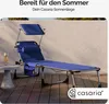 A blue sun lounger with a canopy and pillow is set up on a wooden deck next to a small table with a drink. Produktbild-Vorschau