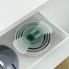 A set of nesting mixing bowls and measuring cups is neatly stored inside a white drawer. Produktbild-Vorschau
