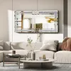 A living room scene with a large decorative mirror above a sectional sofa. Produktbild-Vorschau