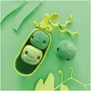 Crocheted peas in a pod and one loose pea on a green background with decorative paper leaves. Produktbild-Vorschau