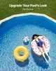 A woman is relaxing in a swimming pool on an inflatable ring, with a beach ball and another inflatable ring nearby. The pool is surrounded by grass and a paved edge. Náhled obrázku produktu