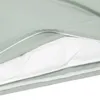 A close-up view of a mint green duvet cover with a white insert visible underneath. Produktbild-Vorschau