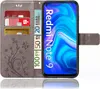 A flip case for a Xiaomi Redmi Note 9 phone, showing the inside with card slots and euro banknotes, and the phone screen displaying a colorful abstract image. Produktbild-Vorschau