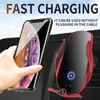 A hand is placing a smartphone into a red wireless car charger mounted on a car's dashboard. Produktbild-Vorschau