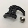 A black bicycle component and a silver screw on a white background. Produktbild-Vorschau