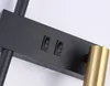 A close-up view of a black and gold wall lamp, showing two switches and a portion of the lamp head. Produktbild-Vorschau