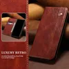 A close-up of a brown leather phone case with a phone inside, showing its card slots. The background is a textured brown surface. Produktbild-Vorschau