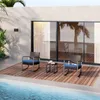 A patio set with two chairs and a table next to a swimming pool, with a modern building and palm trees in the background. Produktbild-Vorschau