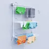 A white wall-mounted drying rack with clothes hanging on it. Produktbild-Vorschau
