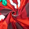 A close-up of a red and brown plaid fabric with a green bow and white elements, likely part of a Christmas decoration. Náhled obrázku produktu